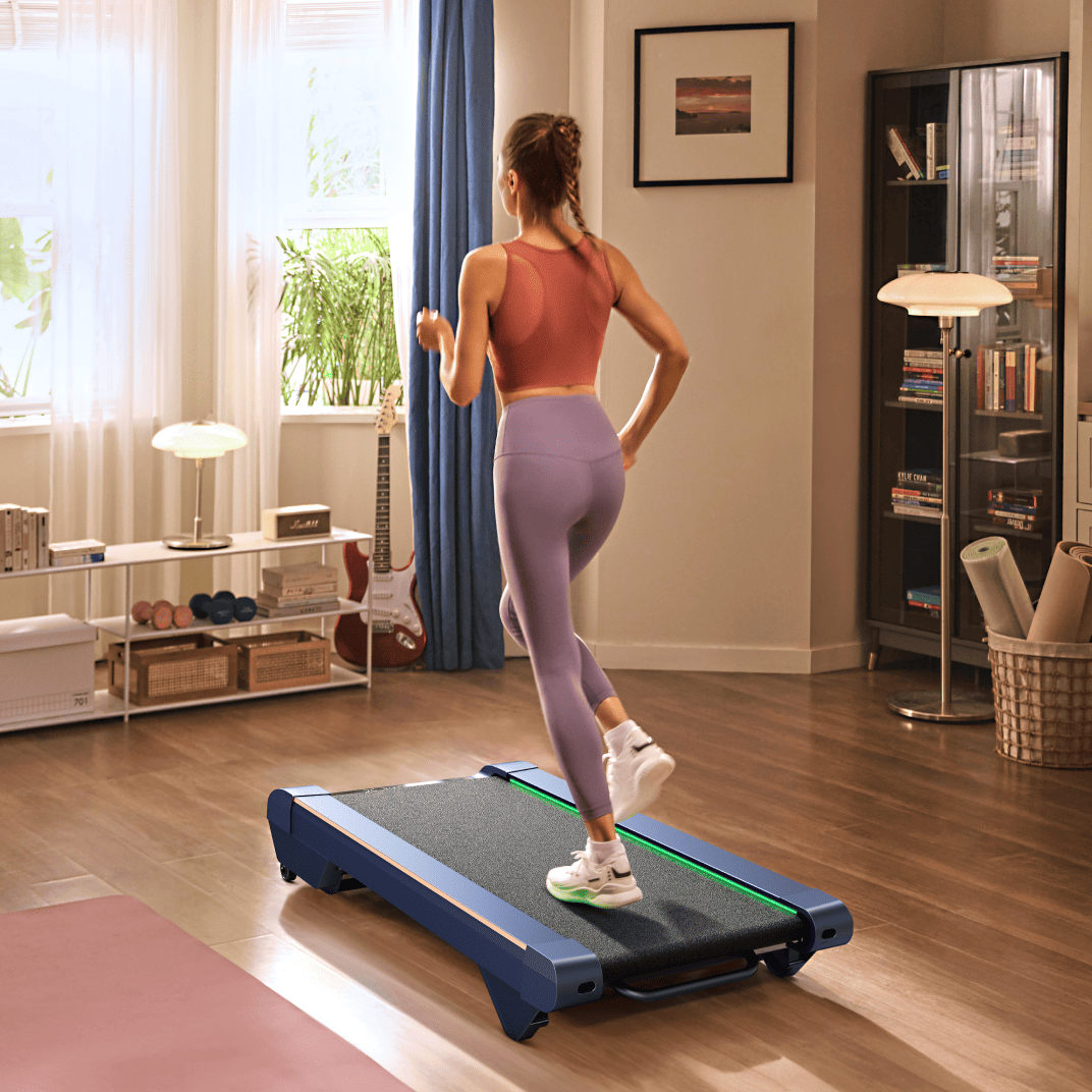 A woman runs on a UREVO CyberPad for Home Treadmill in a cozy, well-lit living room.